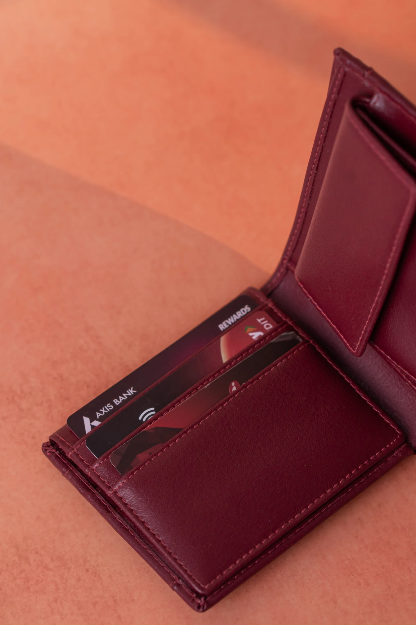 Red vegan leather wallet for men with cards on a brown background