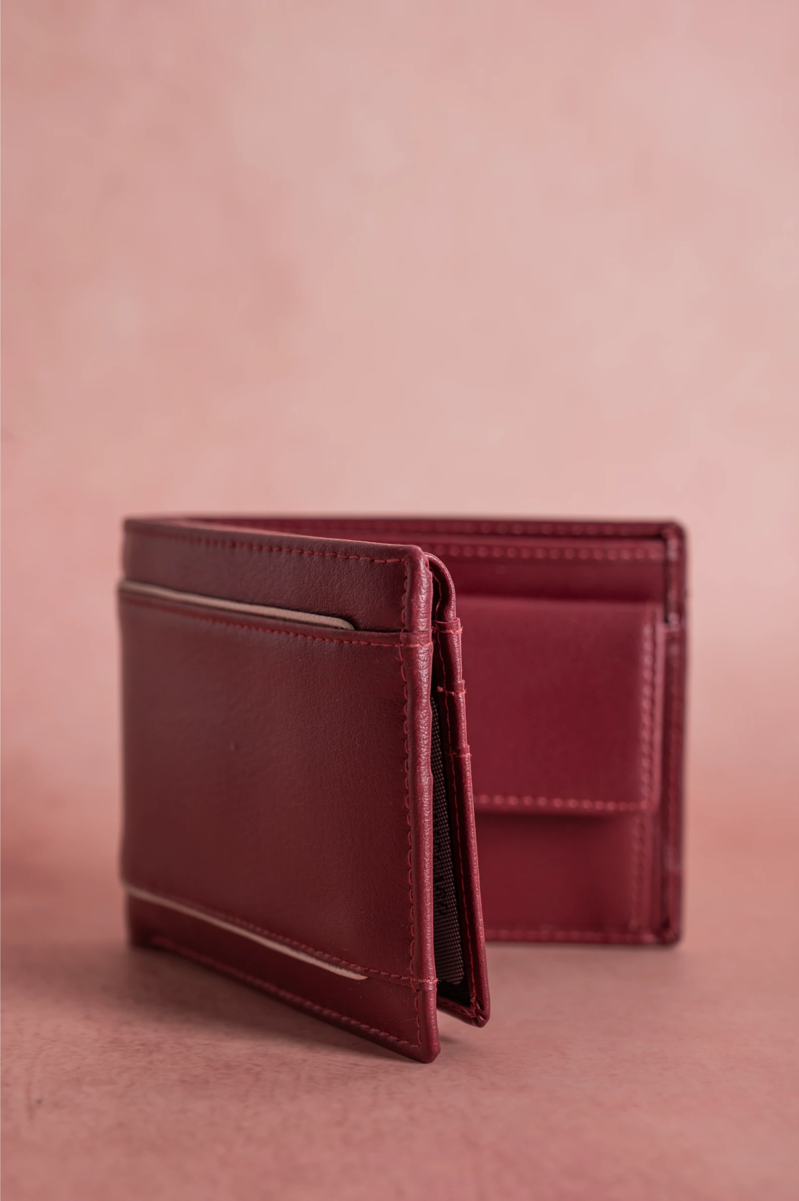 Brown vegan leather wallet for men on a pink background