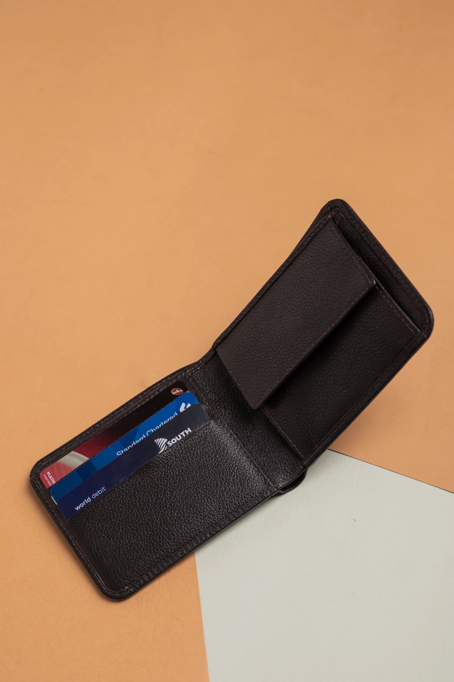 Black vegan leather wallet for women with cards on a beige background