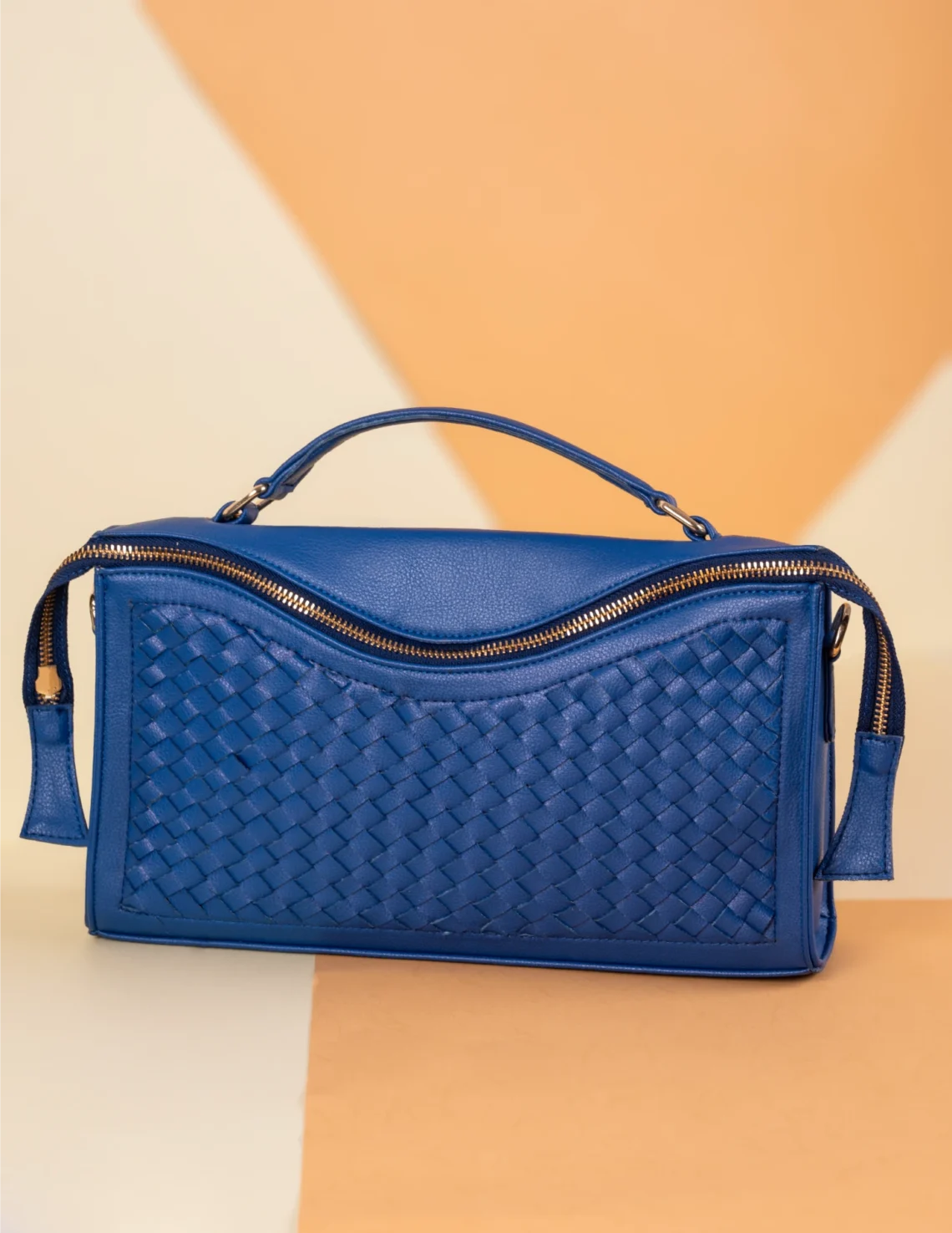 Blue woven vegan leather handbag for women on a two-tone background