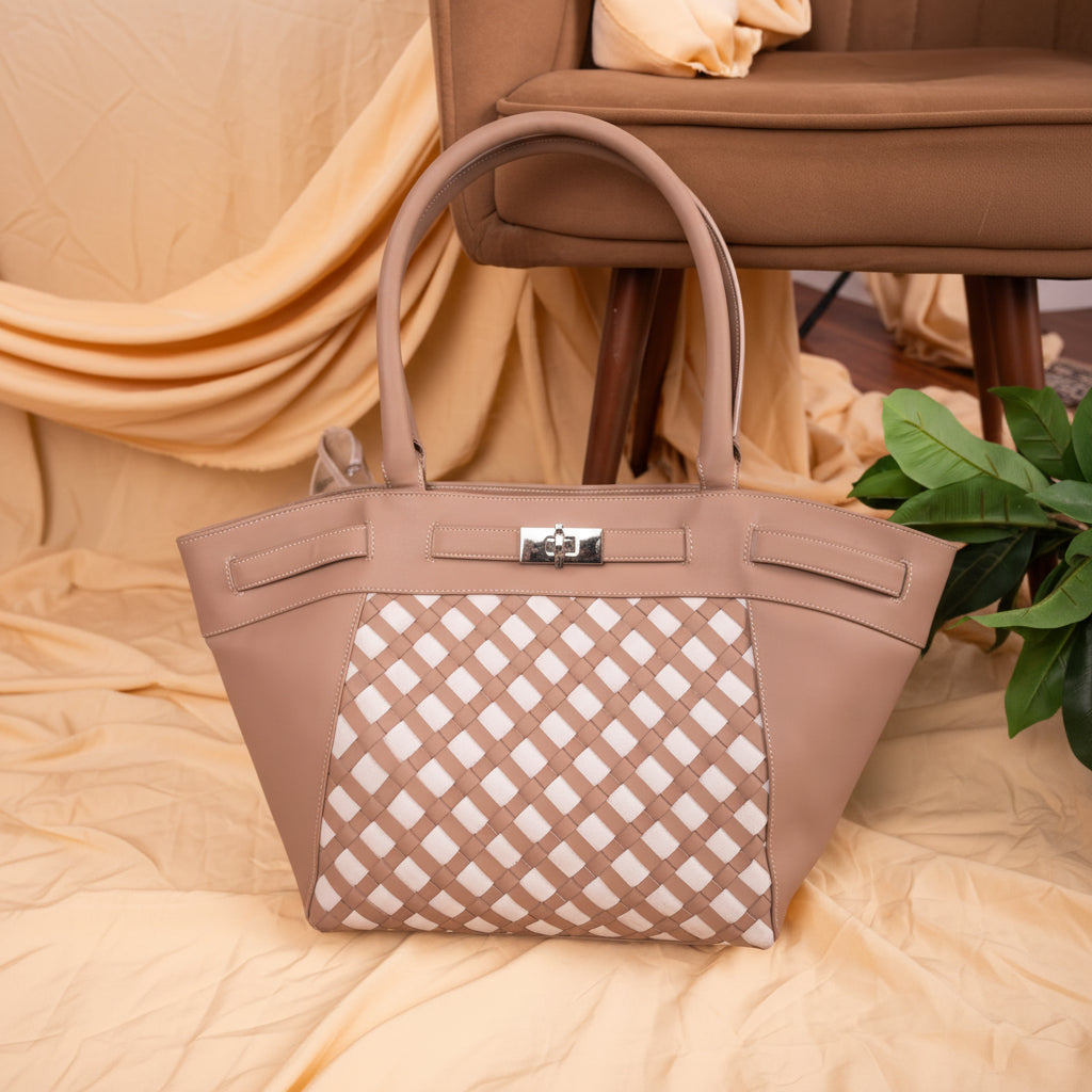 Beige vegan leather handbag for women with a patterned flap on a beige surface