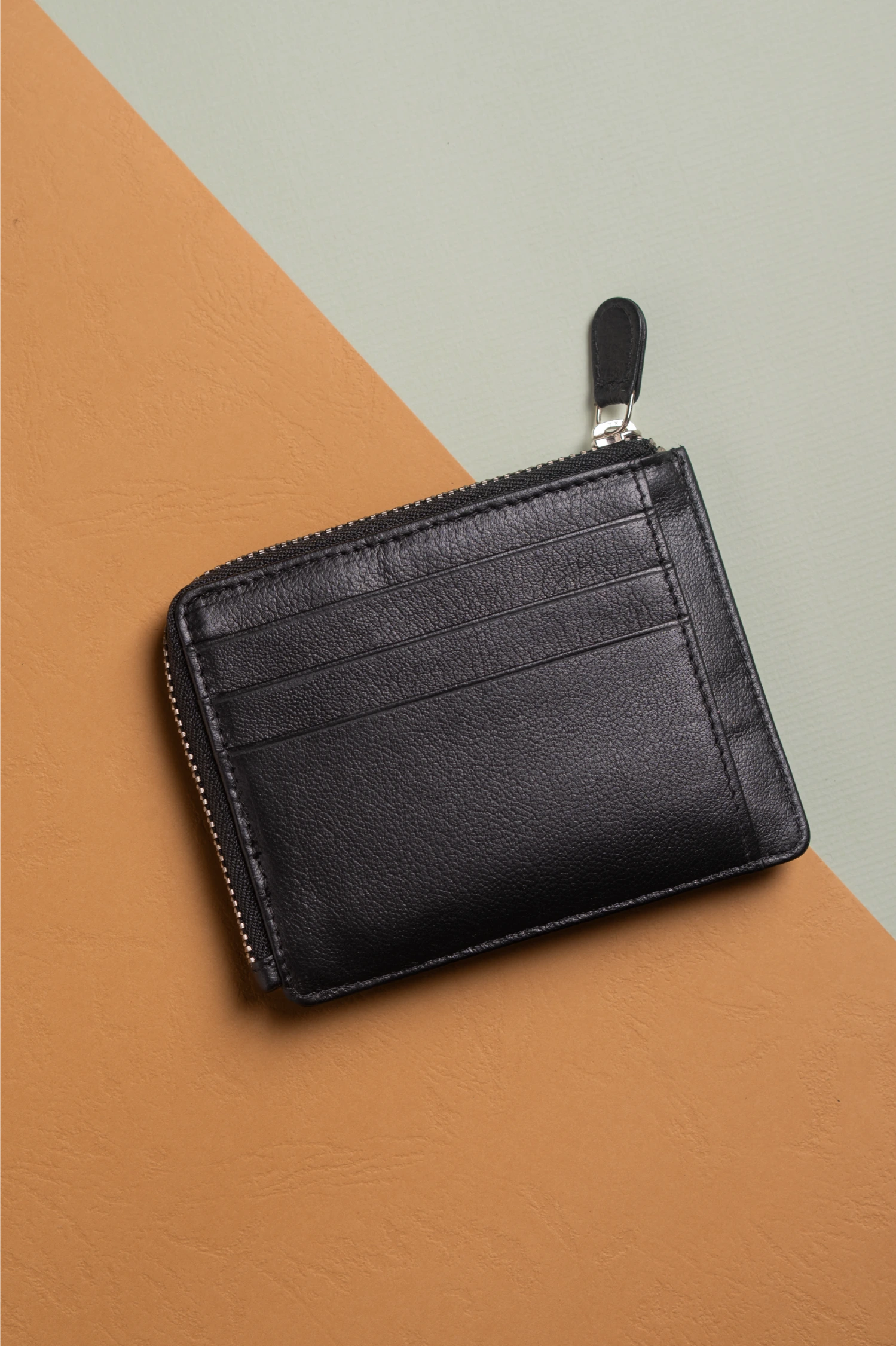 Black vegan leather wallet for women on a brown and gray background