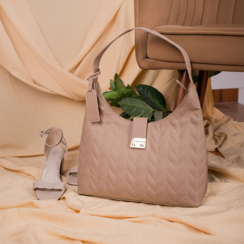 Beige quilted vegan leather handbag for women with a matching sandal on a beige fabric background