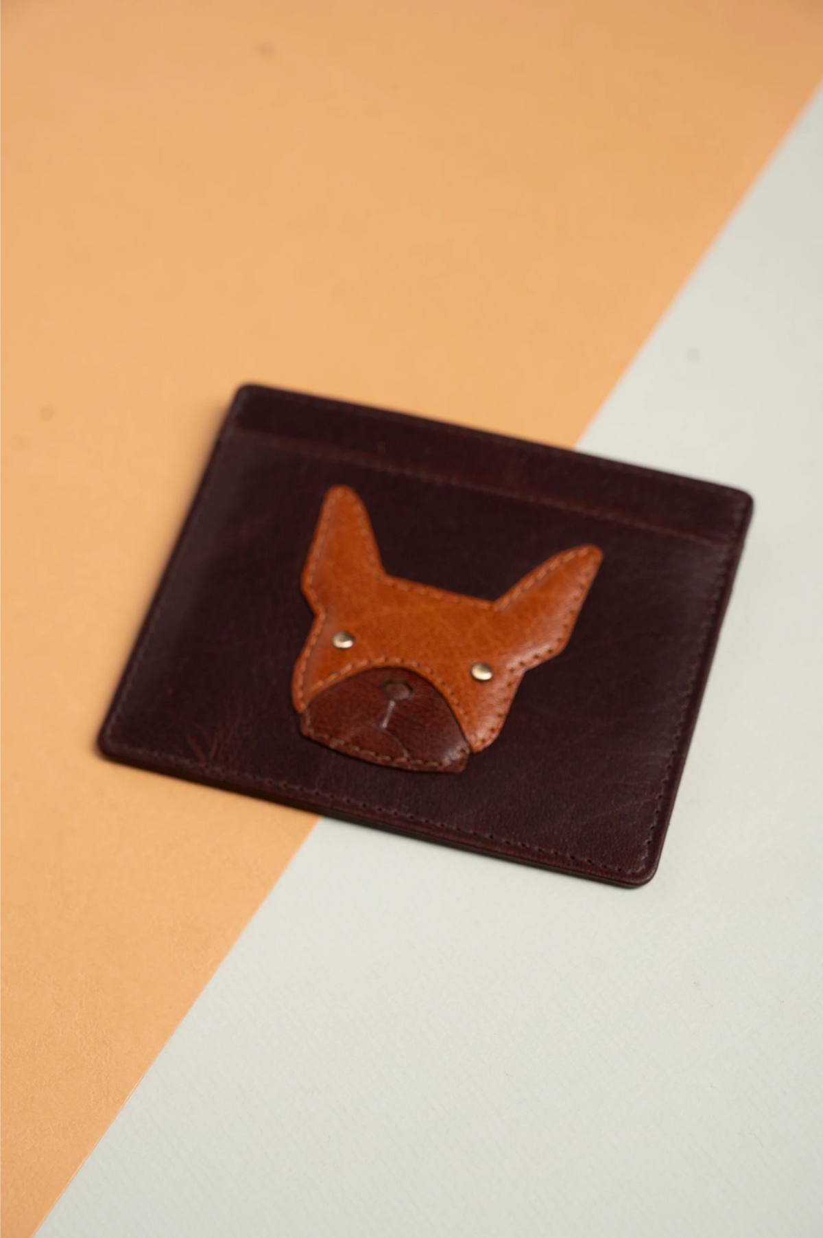 Brown leather vegan wallet for women with fox design on a two-tone background
